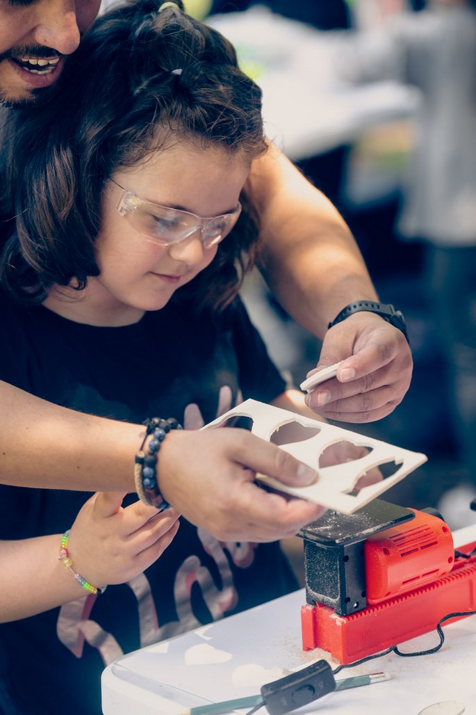 child with parent working on the playmake jig saw