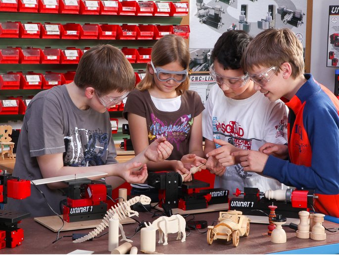 students working with unimat machines and looking at made project