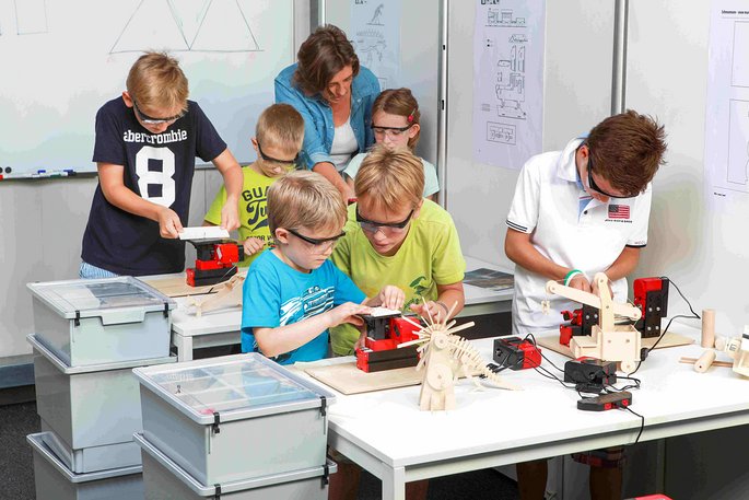 6 students in a classroom working with UNIMAT Elementary machines on differnent projects