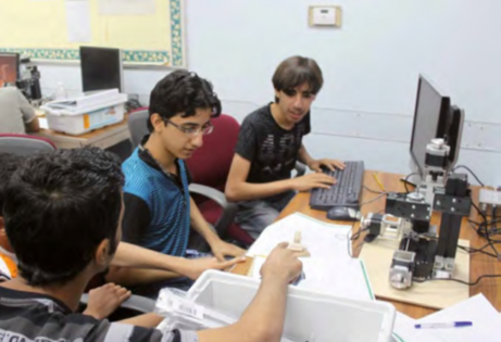 Group of students programming a Unimat cnc machine