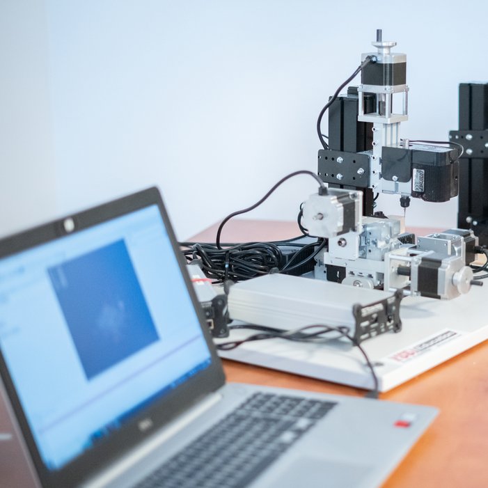 UNIMAT CNC Makerspace machine with a laptop and the software interface