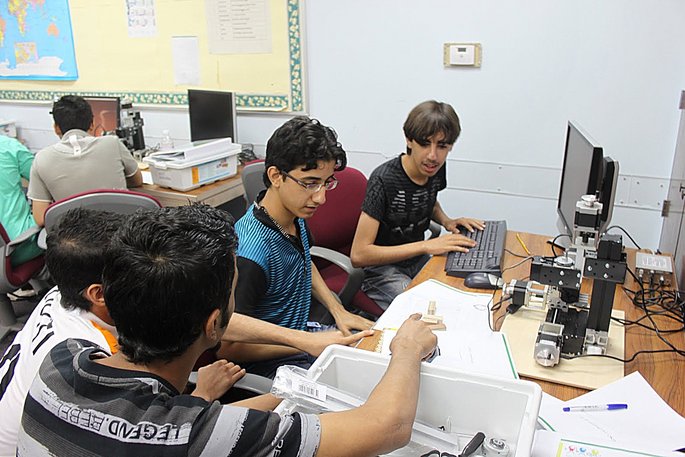 students in a college working with the UNIMAT CNC