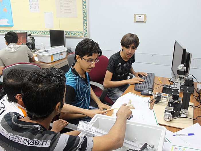students in a technical college working with unimat